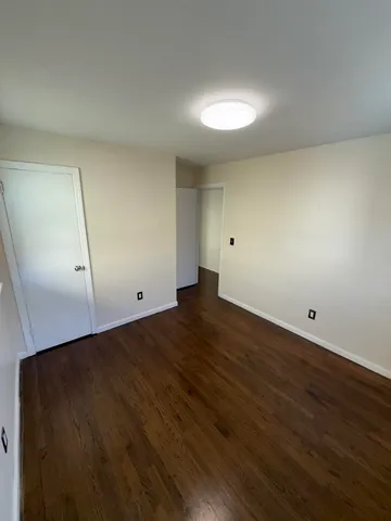 an empty room with wooden floor