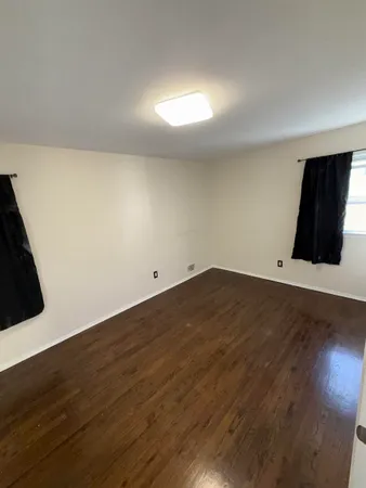 an empty room with wooden floor