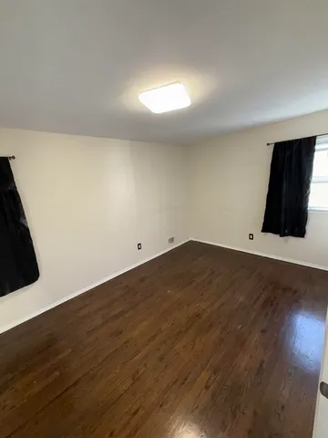 an empty room with wooden floor