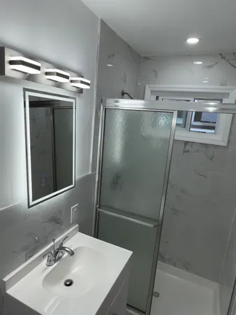 a bathroom with a sink and mirror