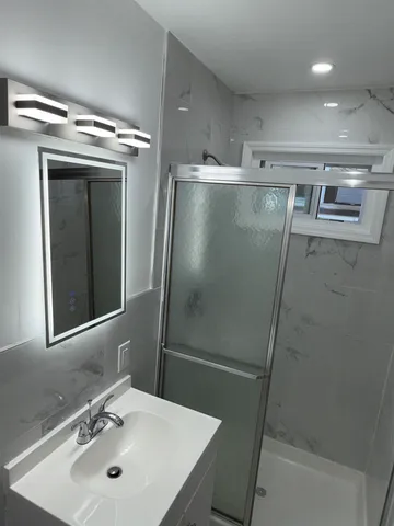 a bathroom with a sink and mirror