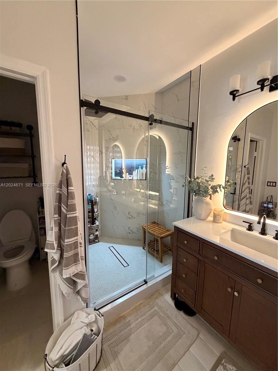2116 Northeast 38th Road, Unit 2116 Homestead, FL 33033 - Photo 16 of 31 a bathroom with a sink a toilet and shower