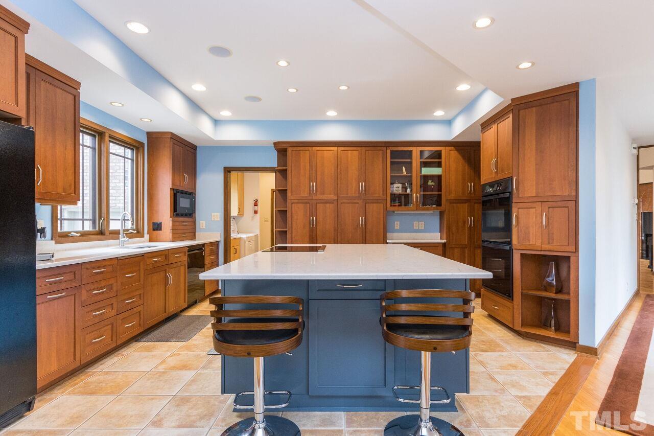 2 Pine Top Place Durham, NC 27705 - Photo 8 of 50 a kitchen with a counter top space a sink stainless steel appliances and cabinets