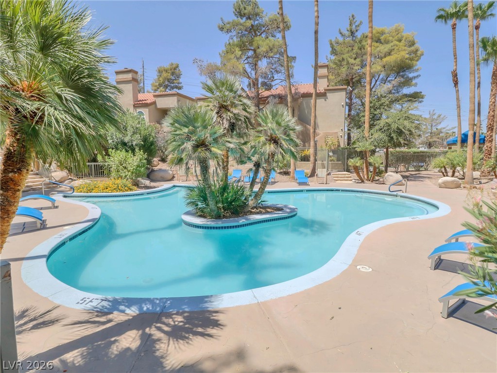 3145 East Flamingo Road, Unit 2129 Las Vegas, NV 89121 - Photo 36 of 43 A lagoon-shaped community pool offers a tropical retreat with abundant palm trees.