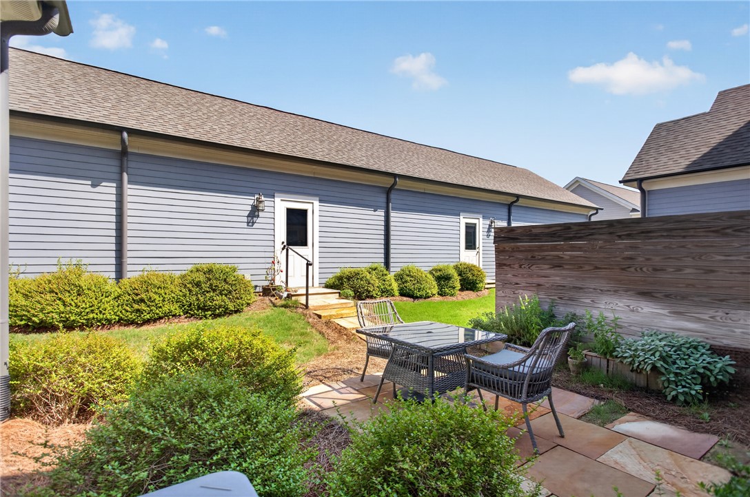 112 Tuttle Street Clemson, SC 29631 - Photo 5 of 46 A tranquil outdoor patio features natural stone pavers, creating a perfect space for al fresco enjoyment.