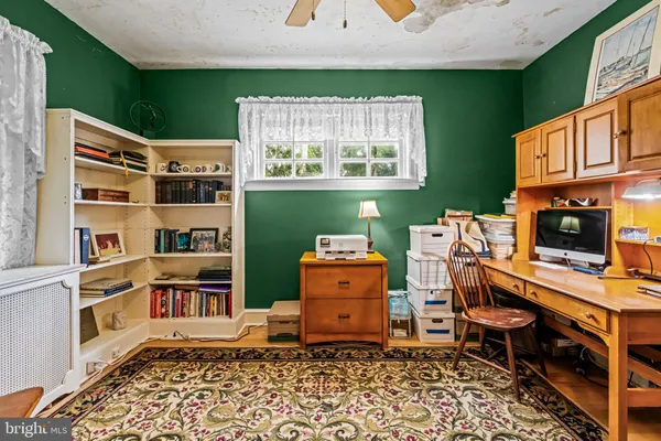 a view of an empty room with closet and wooden floor