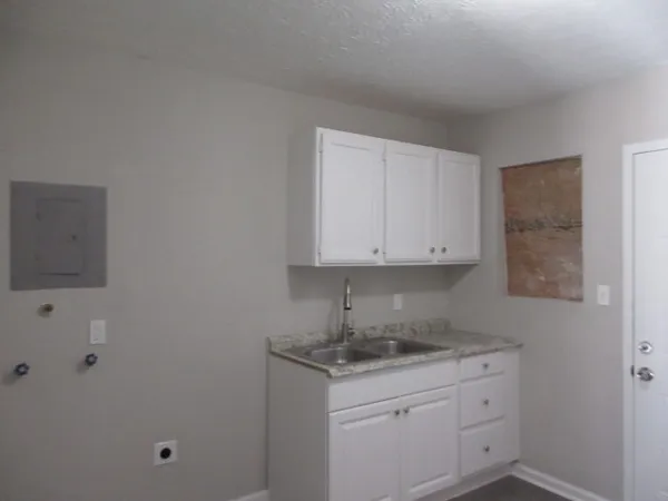 a bathroom with a granite countertop sink and vanity