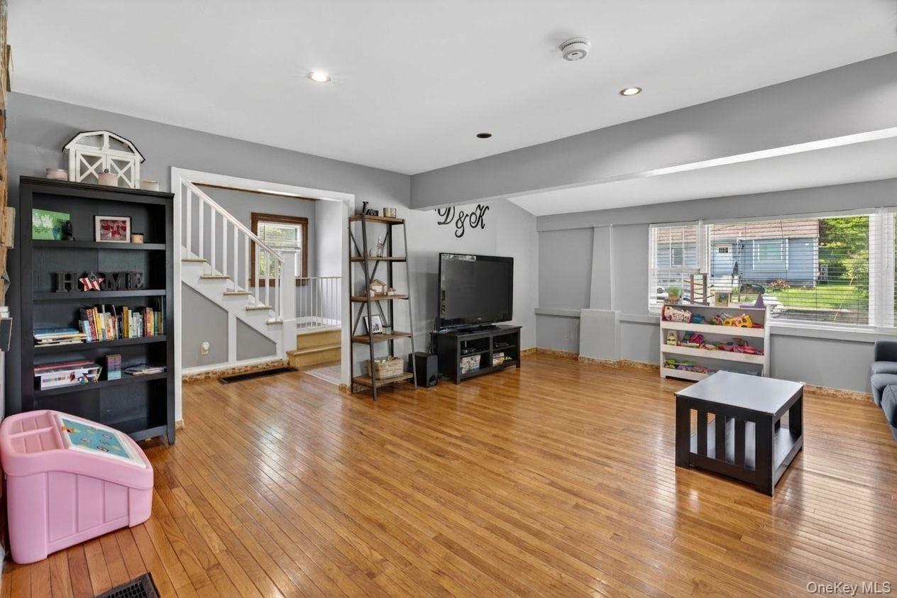 7 Walnut Street Poughkeepsie, NY 12601 - Photo 8 of 30 The spacious living room is filled with natural light, creating a bright and inviting atmosphere that feels both comfortable and welcoming