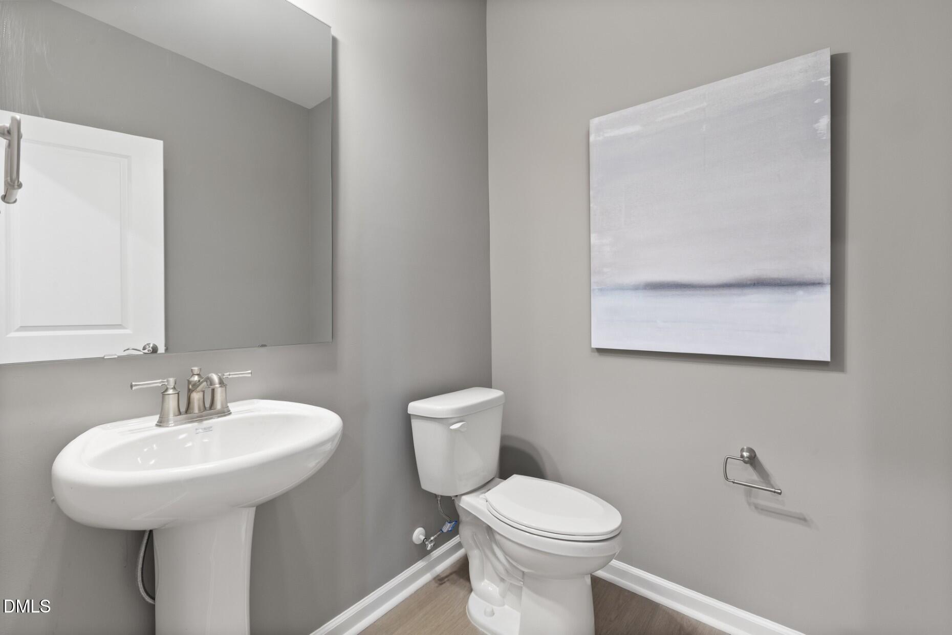 2901 Denson Road Fuquay-Varina, NC 27526 - Photo 22 of 31 a bathroom with a toilet sink and mirror