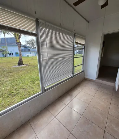 a view of a room with window and carpet