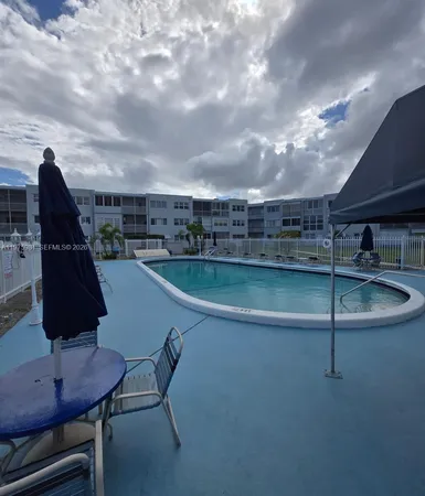 a view of a swimming pool with a table and chairs