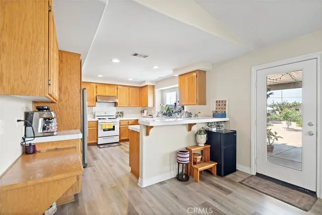 a kitchen with a table chairs refrigerator and cabinets