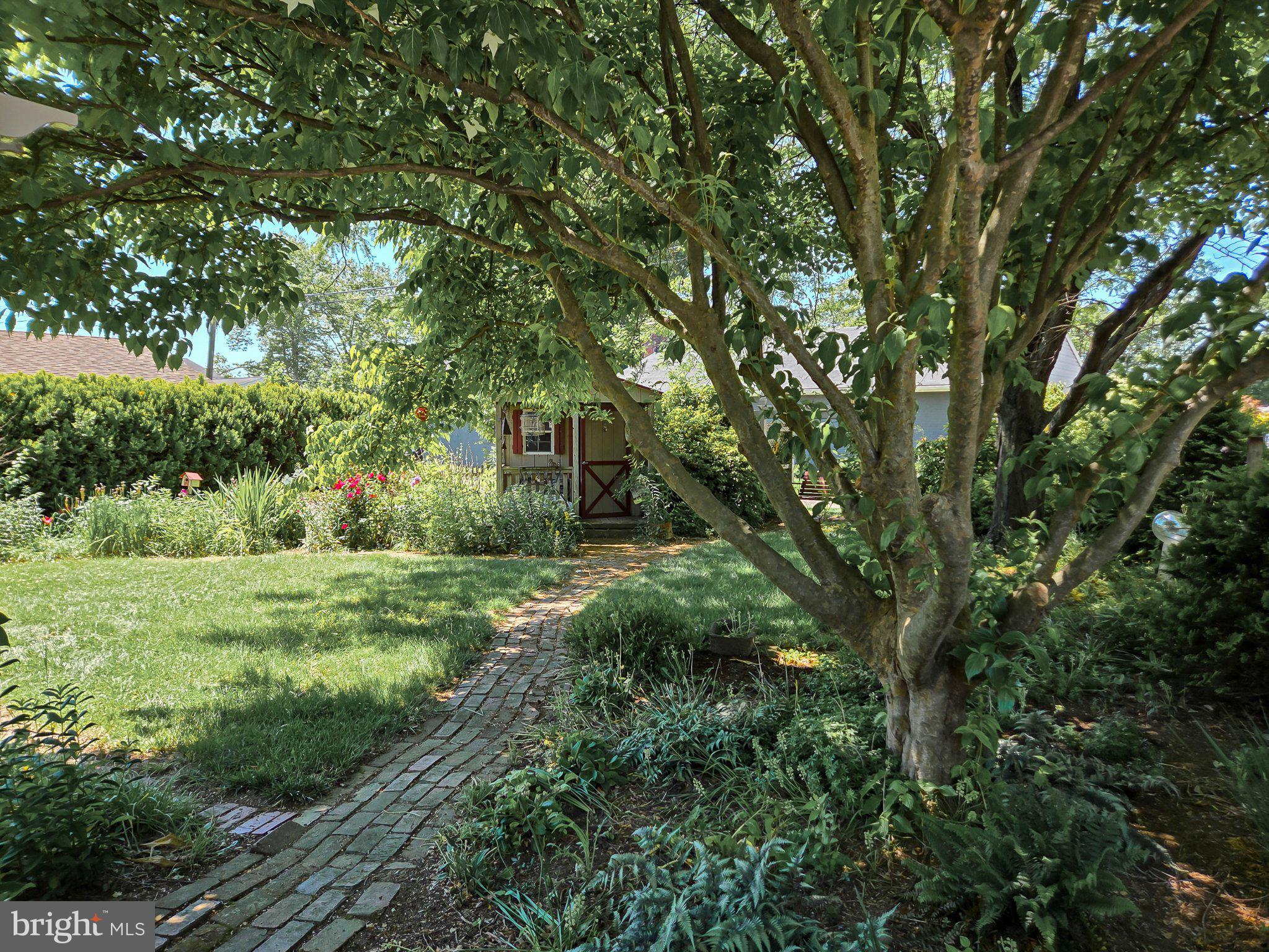 524 Locust Street Denver, PA 17517 - Photo 31 of 36 Serene garden path beneath trees.