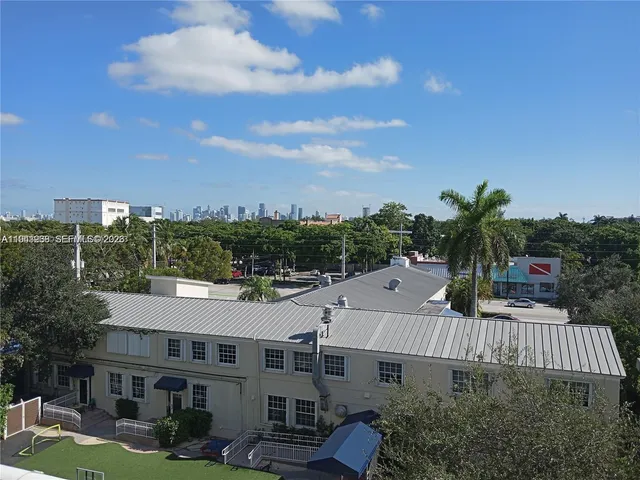 a view of a city with lush green forest
