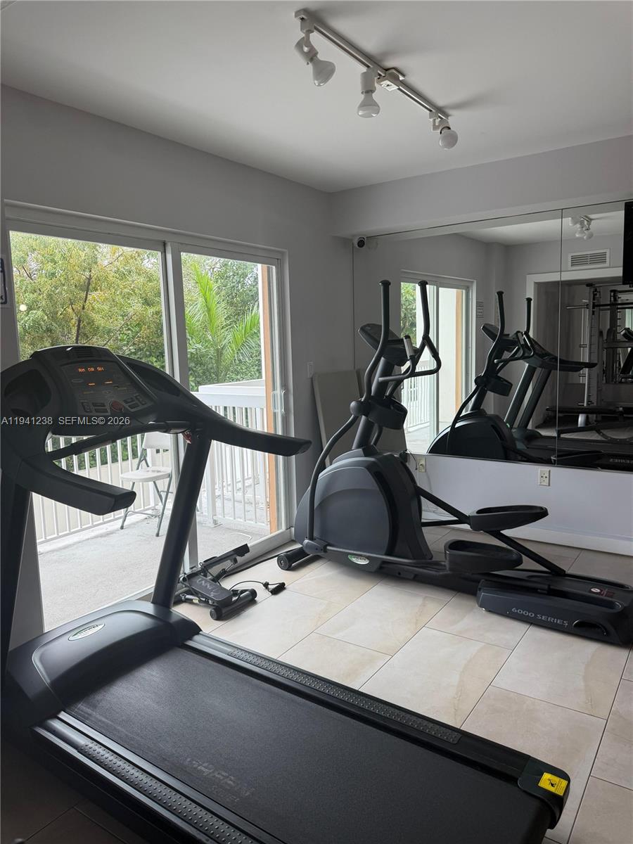 2740 Southwest 28th Terrace, Unit 507 Miami, FL 33133 - Photo 24 of 29 a room with gym equipment and a large window
