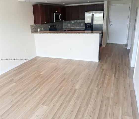a view of a kitchen from the hallway