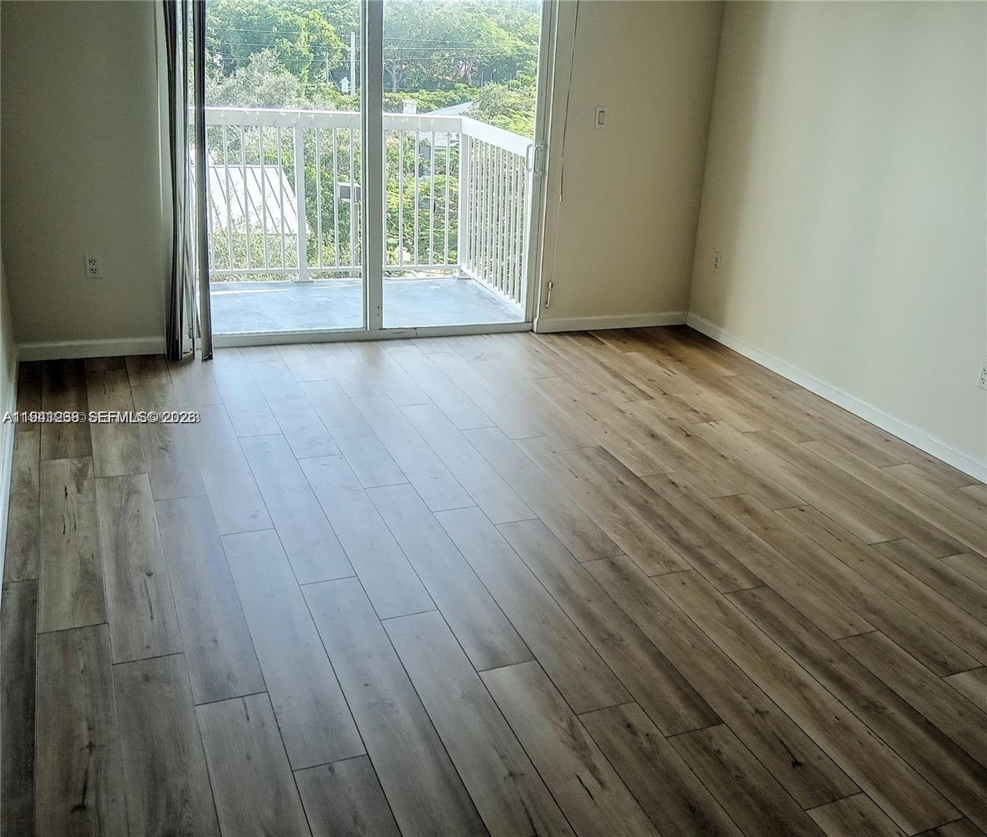 2740 Southwest 28th Terrace, Unit 507 Miami, FL 33133 - Photo 6 of 29 a view of empty room with wooden floor and fan