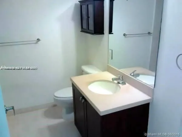 a bathroom with a sink toilet and a mirror