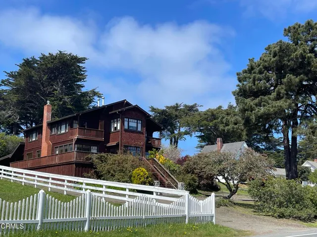 an aerial view of residential houses with outdoor space and swimming pool