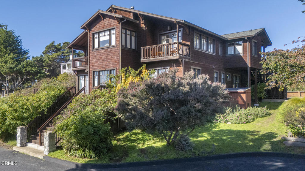 a front view of a house with a yard and plants