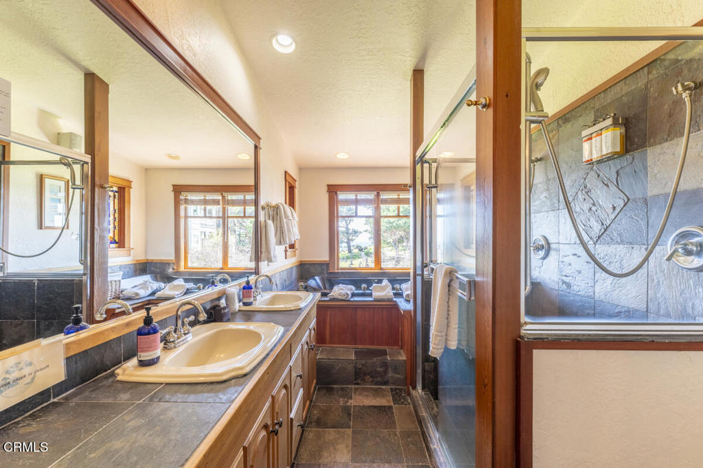 44920 Little Lake Road Mendocino, CA 95460 - Photo 15 of 62 a spacious bathroom with a double vanity sink a mirror and a bathtub