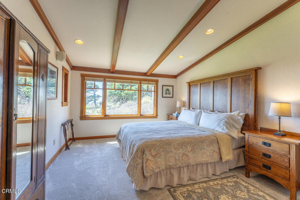 44920 Little Lake Road Mendocino, CA 95460 - Photo 16 of 62 a spacious bedroom with a bed and a large window
