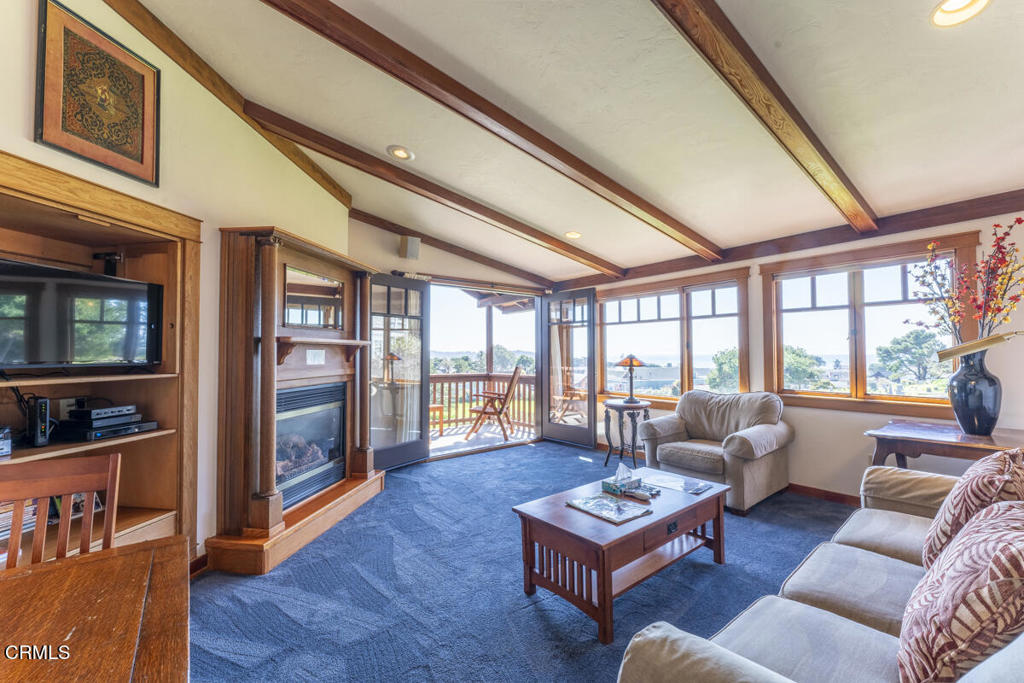 44920 Little Lake Road Mendocino, CA 95460 - Photo 18 of 62 a living room with furniture a flat screen tv and a floor to ceiling window