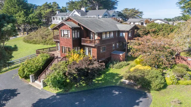 an aerial view of a house with a yard and garden