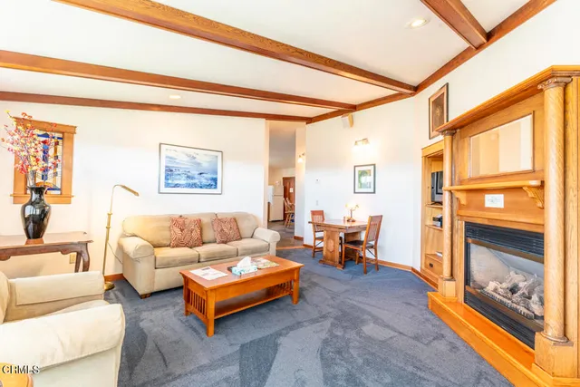 a view of a bedroom with wooden floor and a bathroom