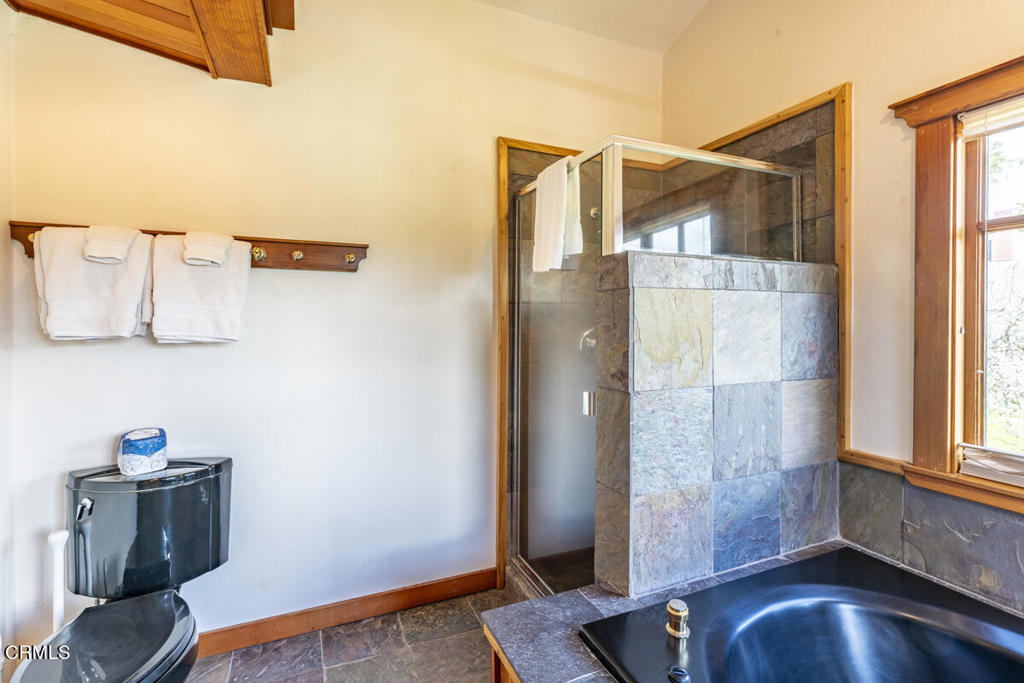 44920 Little Lake Road Mendocino, CA 95460 - Photo 27 of 62 a view of a bedroom with wooden floor and a bathroom