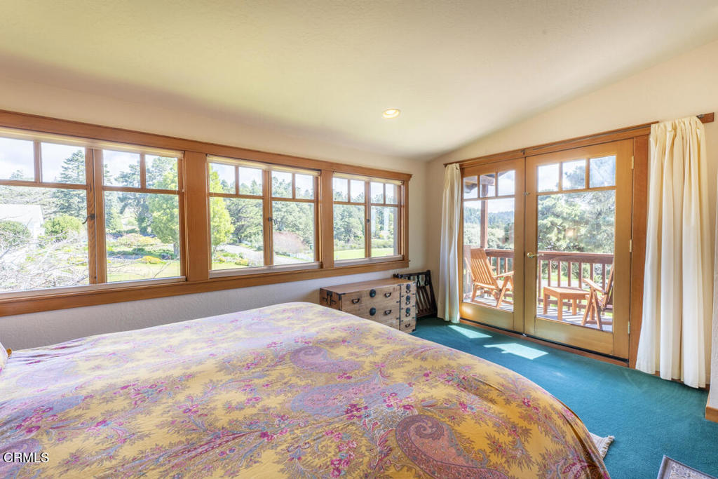 44920 Little Lake Road Mendocino, CA 95460 - Photo 29 of 62 a spacious bedroom with a large bed and a large window