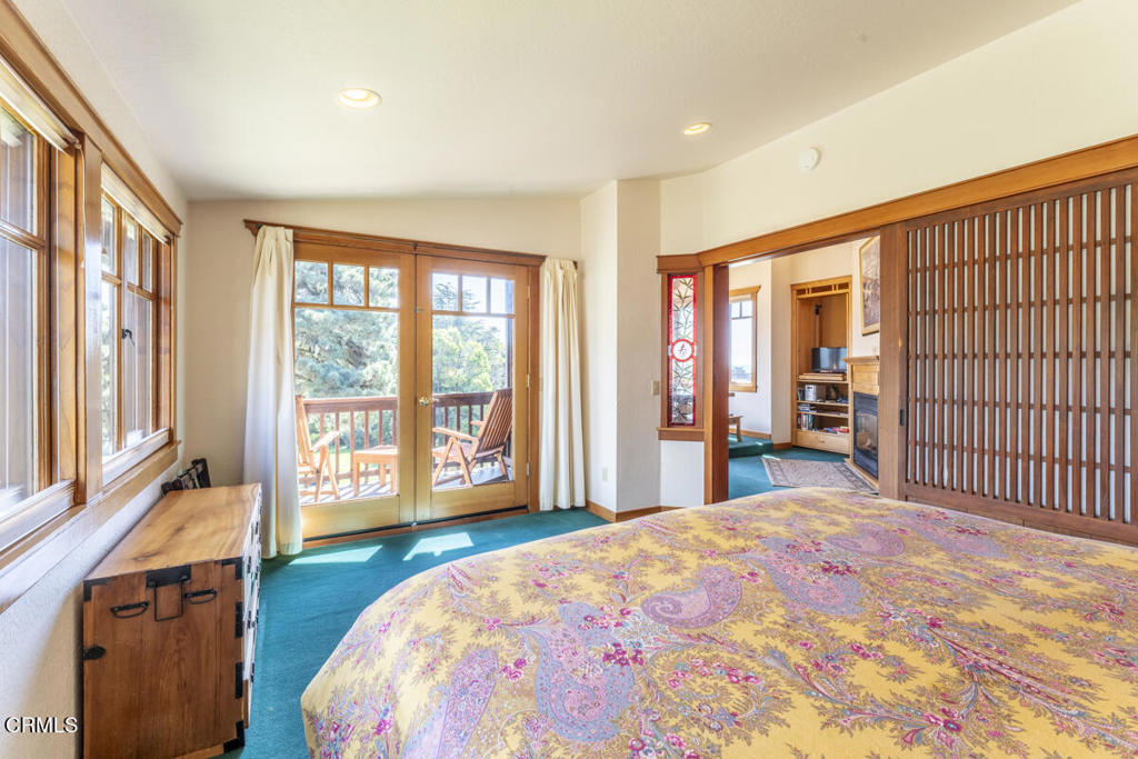 44920 Little Lake Road Mendocino, CA 95460 - Photo 30 of 62 a spacious bedroom with a large bed and a large window