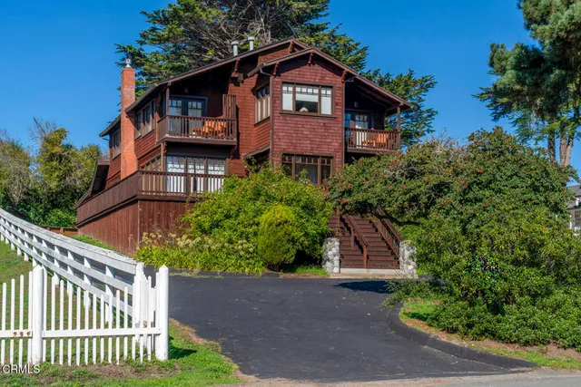 a front view of a house with a yard and plants