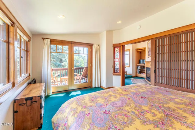 a living room with fireplace furniture and a large window