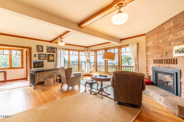 a living room with large windows and wooden floor