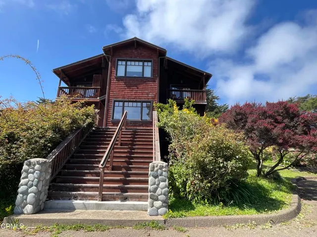 a kitchen with stainless steel appliances granite countertop wooden floors and white cabinets