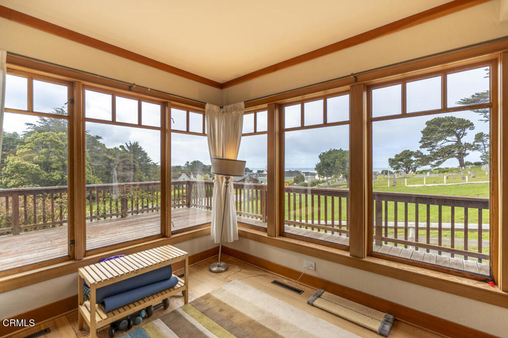44920 Little Lake Road Mendocino, CA 95460 - Photo 56 of 62 a living room with large windows and wooden floor