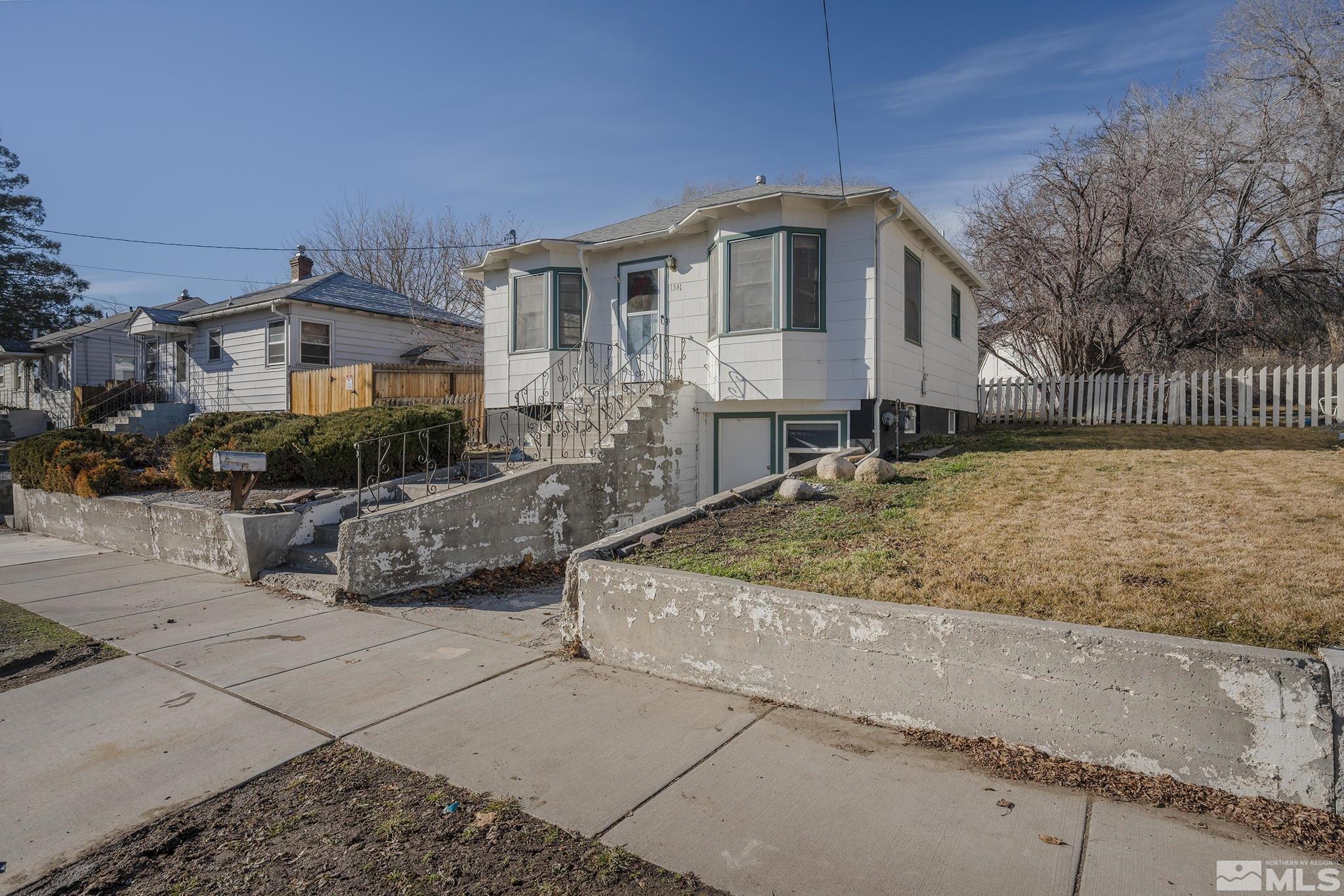 1341 Faland Way Reno, NV 89503 - Photo 2 of 16 a front view of a house with cars parked
