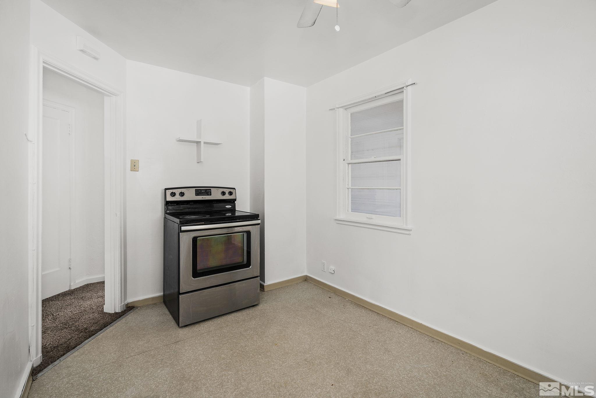 1341 Faland Way Reno, NV 89503 - Photo 8 of 16 a kitchen with a stove and a microwave