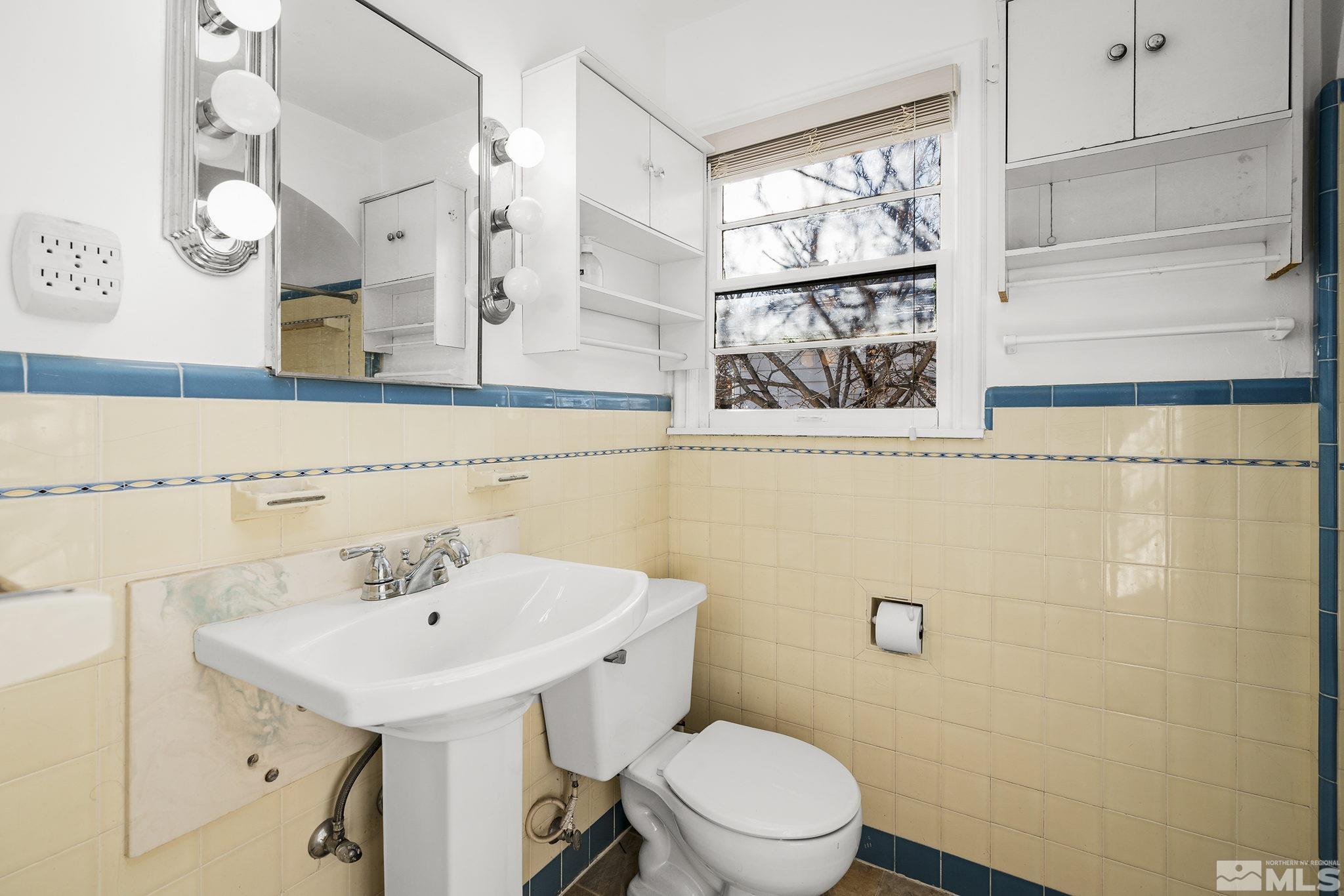 1341 Faland Way Reno, NV 89503 - Photo 10 of 16 a bathroom with a sink a mirror and a toilet