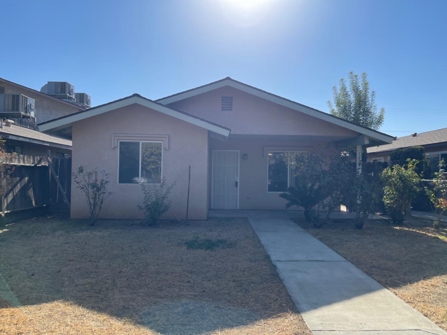 1229 E Street Reedley, CA 93654 - Photo 1 of 25 a view of a house with a street