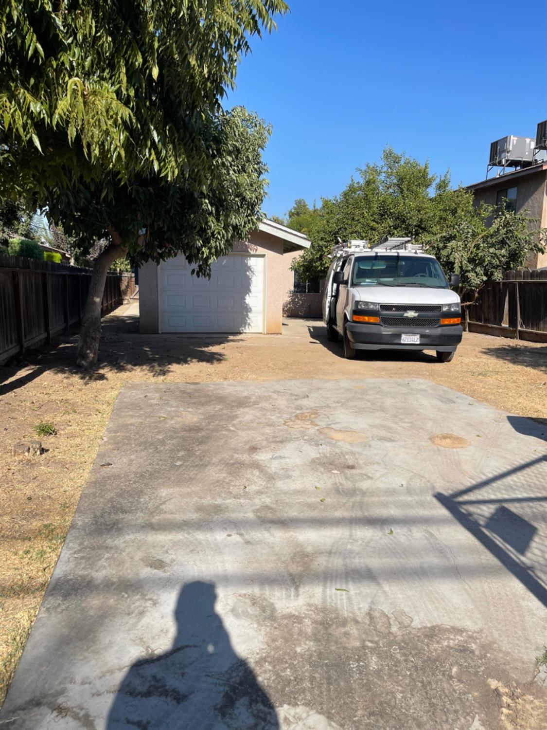 1229 E Street Reedley, CA 93654 - Photo 7 of 25 a car parked in front of a white house