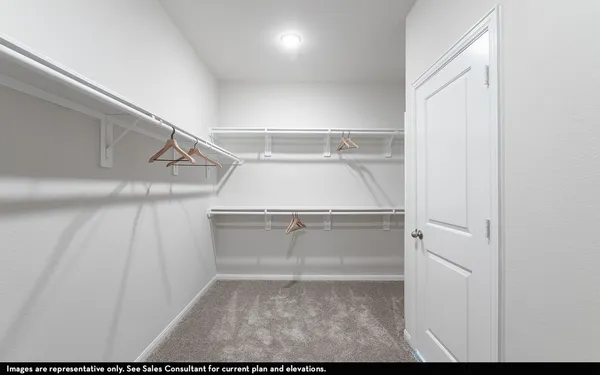 a view of walk in closet with racks
