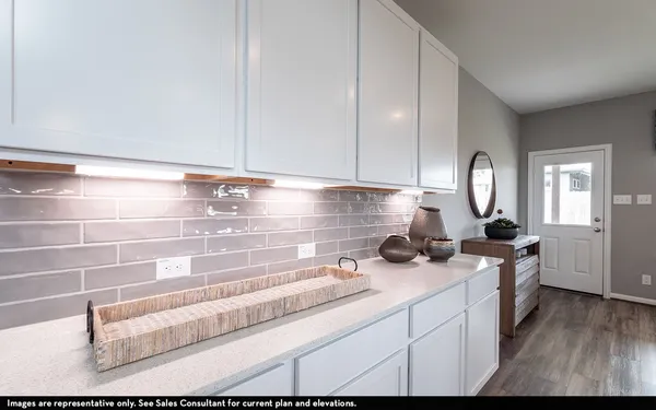a kitchen with a cabinets and wooden floor