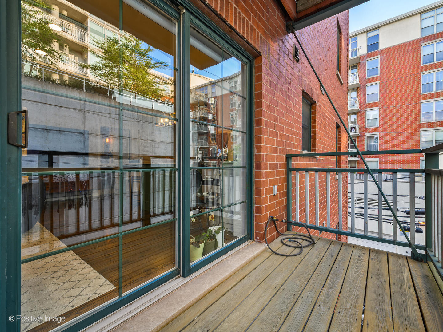1038 West Monroe Street, Unit 34 Chicago, IL 60607 - Photo 11 of 28 a view of a balcony with wooden floor