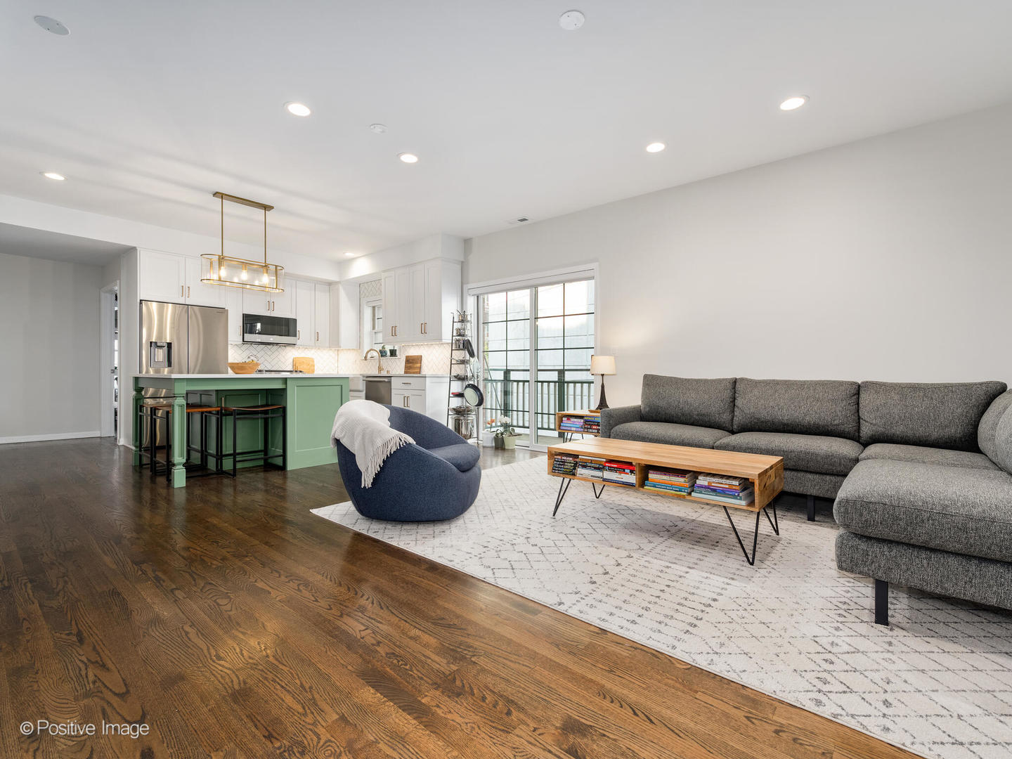 1038 West Monroe Street, Unit 34 Chicago, IL 60607 - Photo 5 of 28 a living room with furniture and a kitchen view with wooden floor