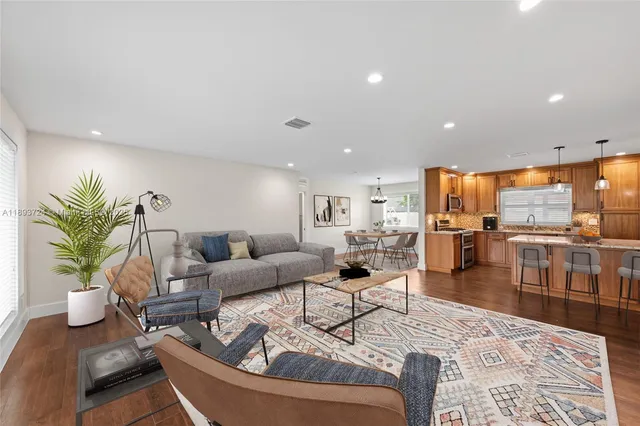 a living room with furniture a couch and a potted plant