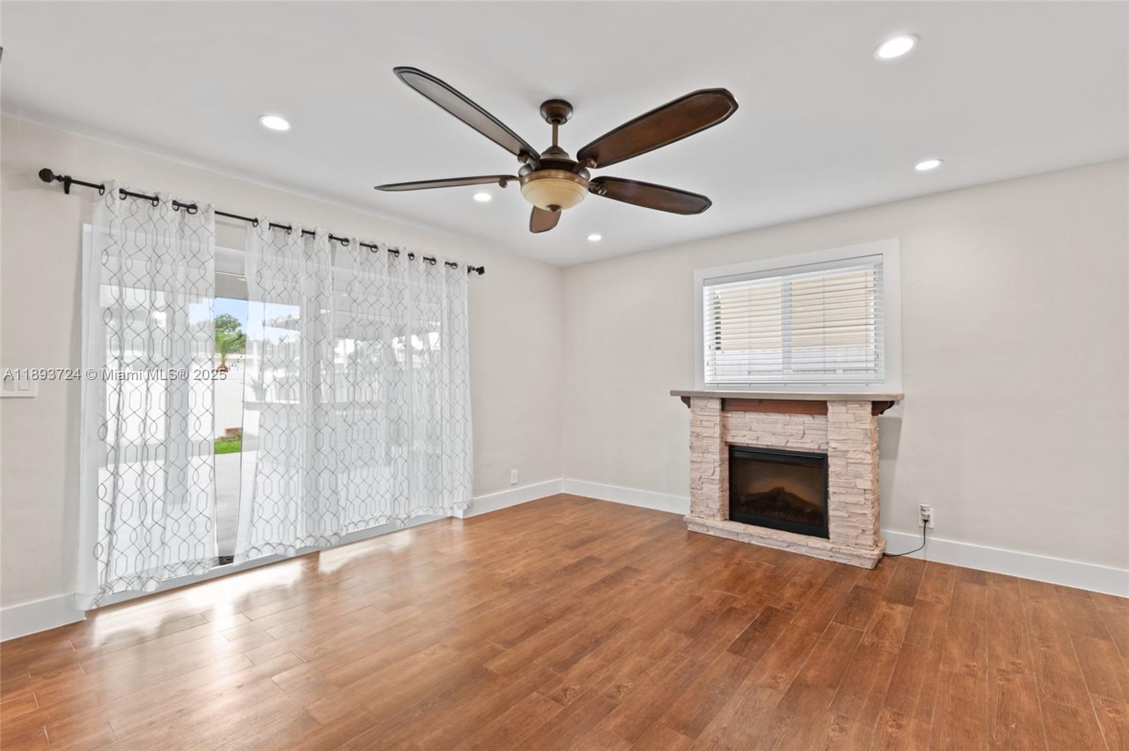 8440 Southwest 201st Street Cutler Bay, FL 33189 - Photo 12 of 31 a view of an empty room with window and wooden floor
