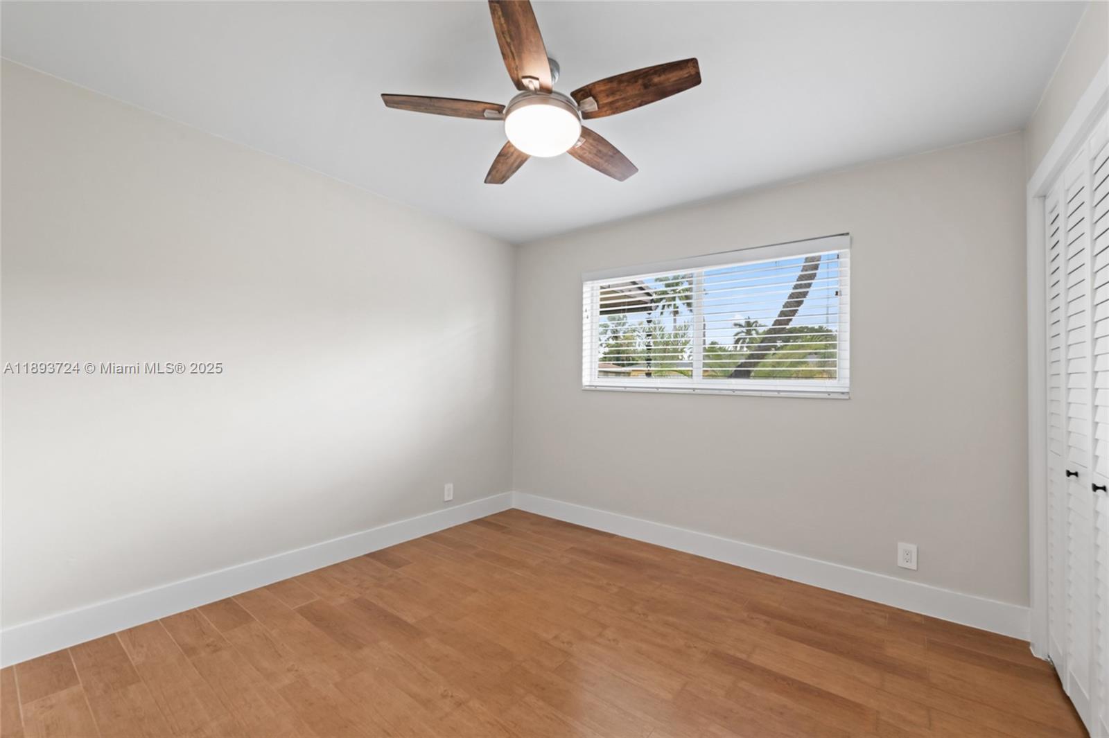 8440 Southwest 201st Street Cutler Bay, FL 33189 - Photo 14 of 31 an empty room with a window and a ceiling fan