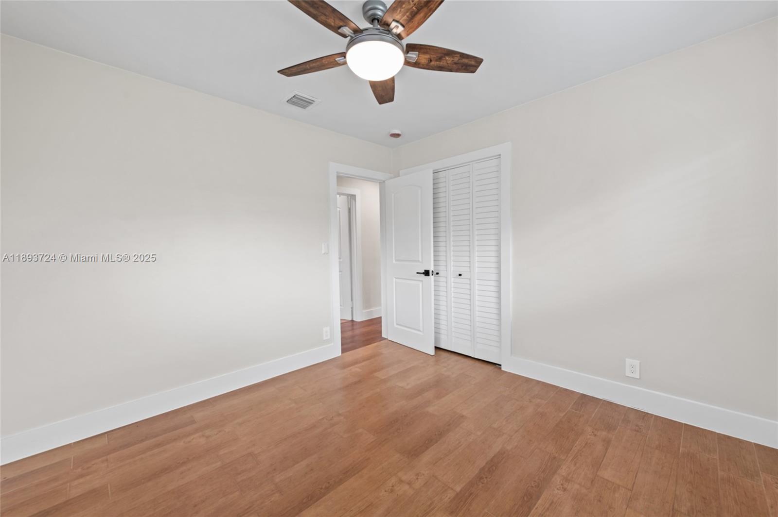 8440 Southwest 201st Street Cutler Bay, FL 33189 - Photo 15 of 31 wooden floor in an empty room